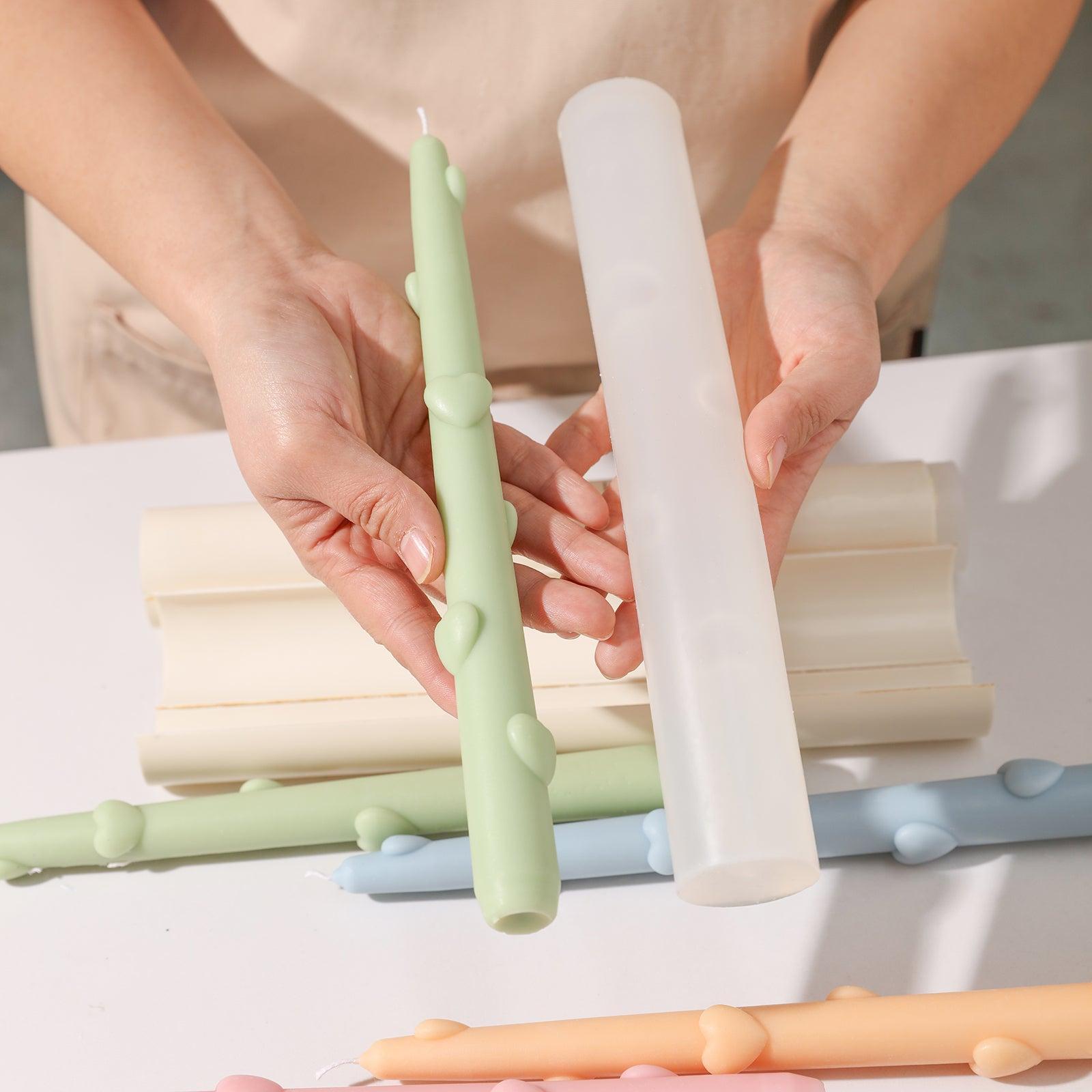 Showcase the finished candles and the Love Heart Taper Candle Silicone Mold after a seamless demolding process.