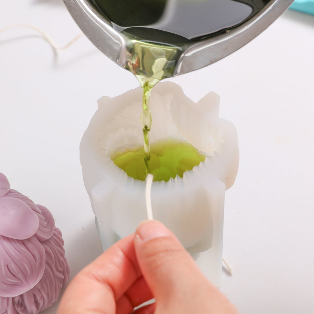 Pour green wax liquid into silicone molds to make miniature fairy house candles - Boowan Nicole