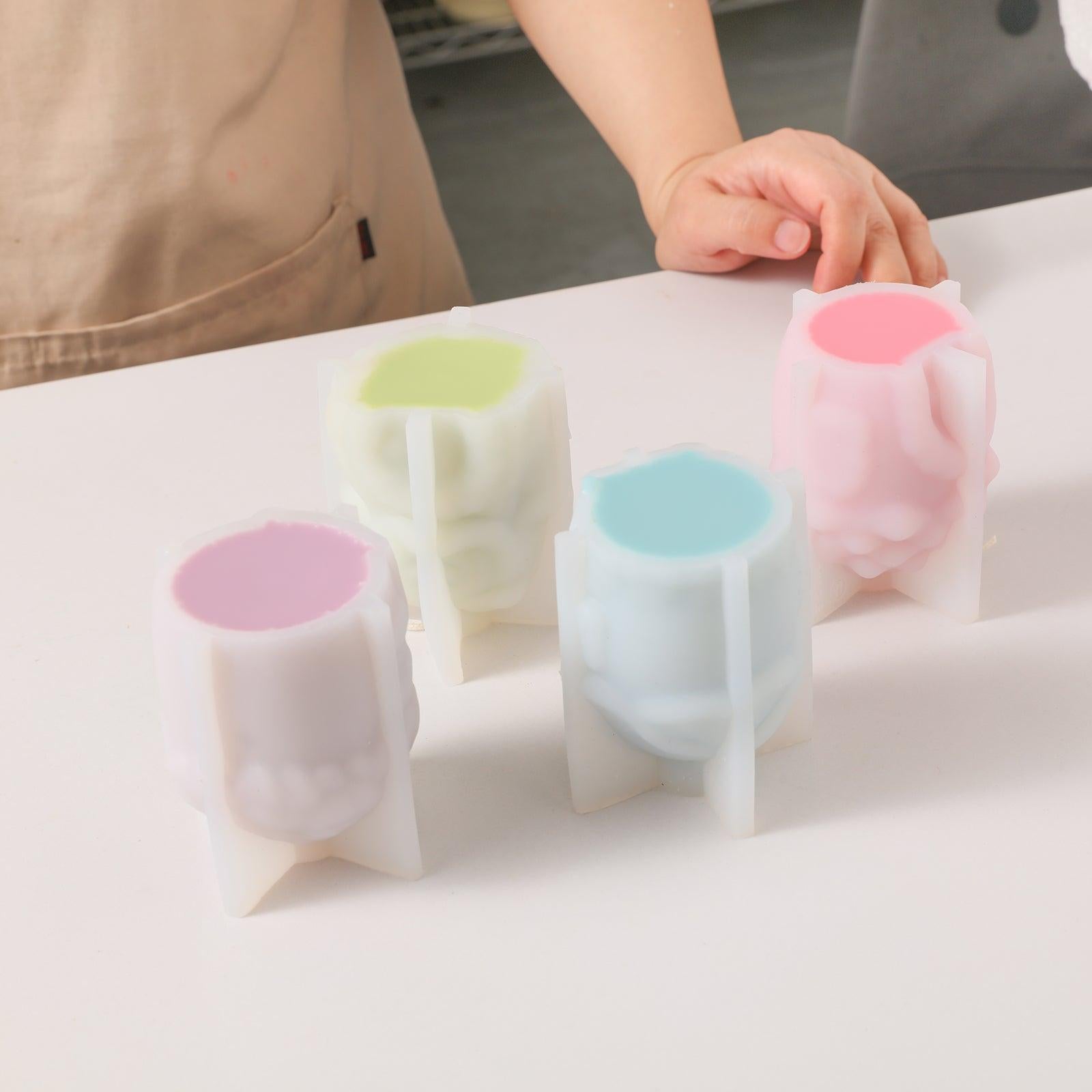 The pink, blue, purple and green wax liquid is injected into the silicone mold and waits for solidification-Boowan Nicole