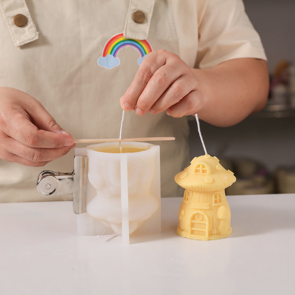 Pour liquid wax into silicone molds to create miniature mushroom house candles -Boowan Nicole