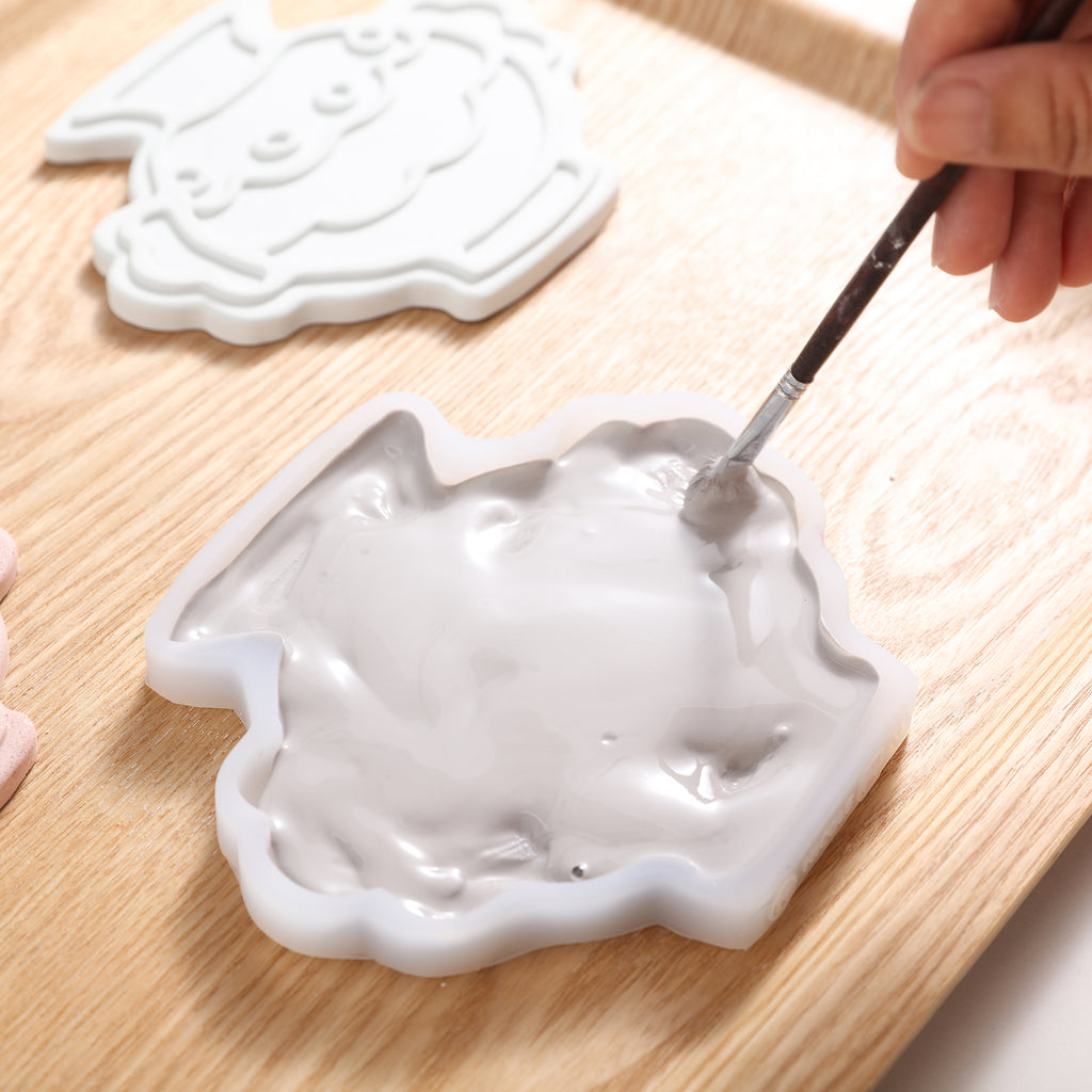 Pour Boowannite into silicone molds and use a brush to remove air bubbles, designed by Boowan Nicole.