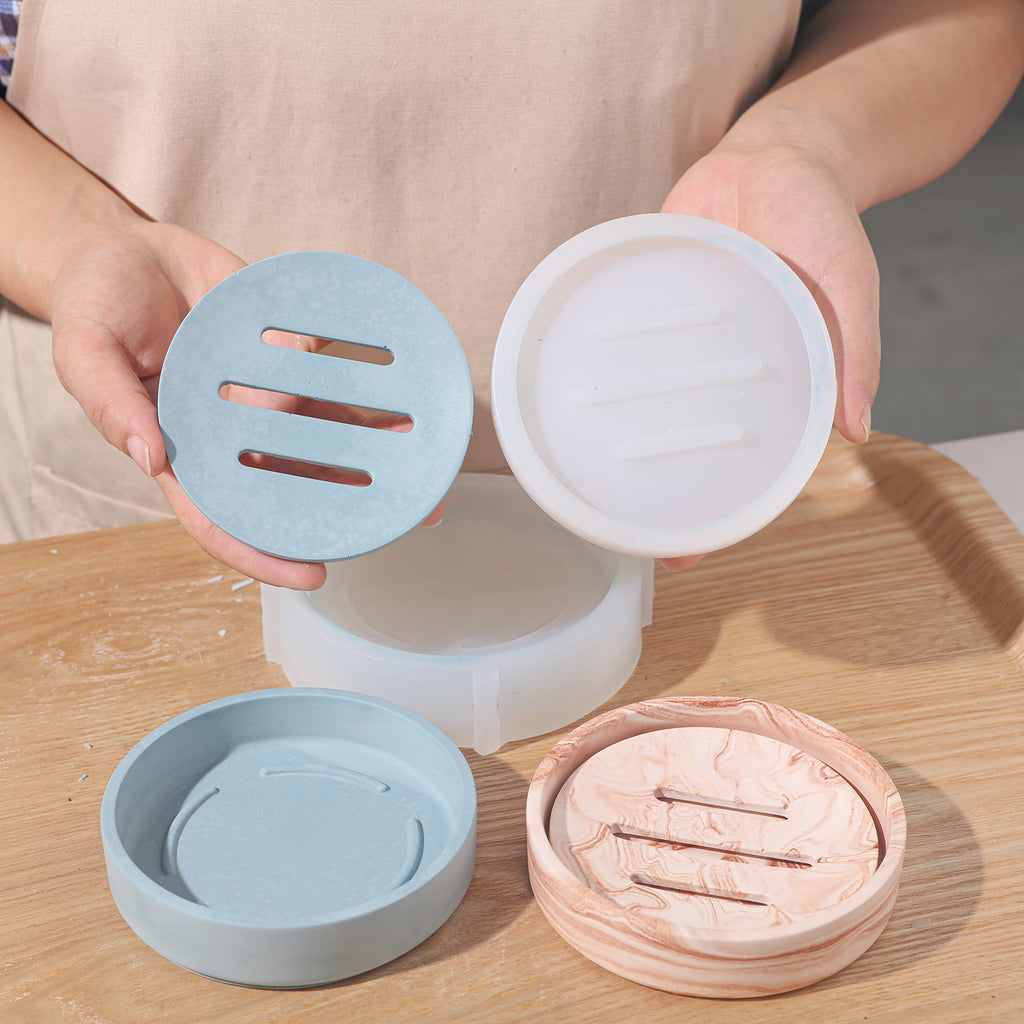 Handheld demonstration using silicone molds to make soap drain pans and corresponding silicone molds.