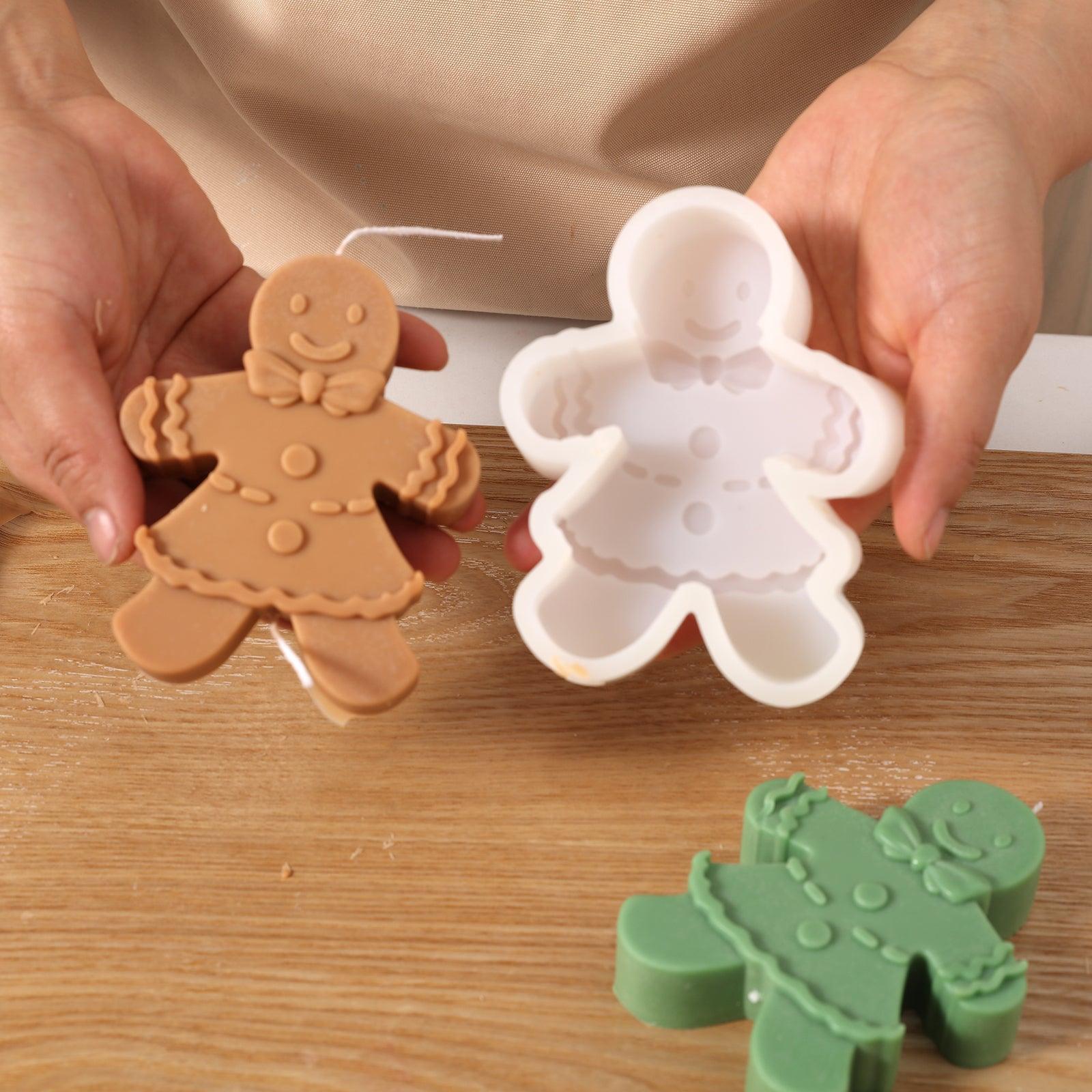 Hand-held display of brown Gingerbread Mama Candle and white silicone mold - Boowan Nicole