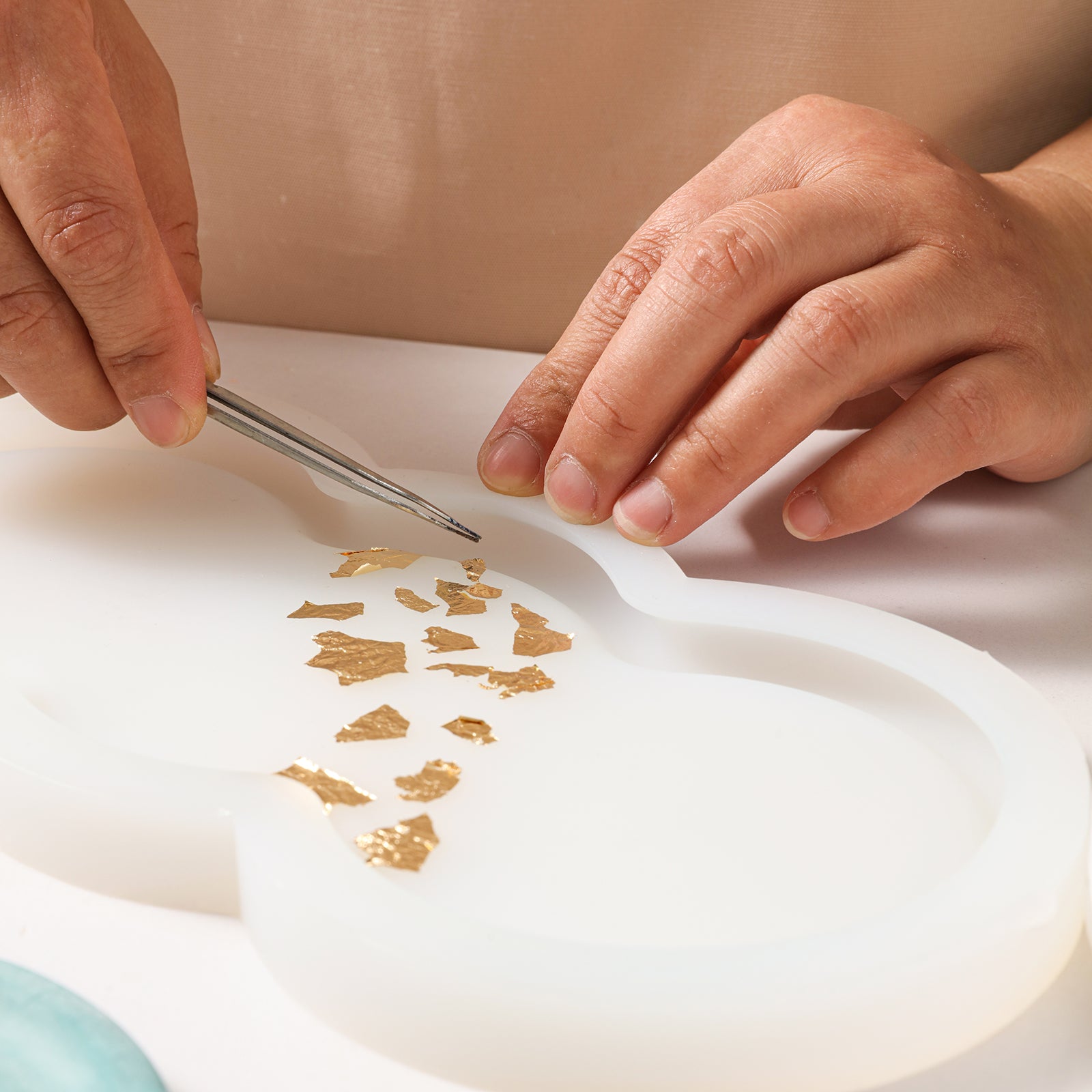 Place gold foil on white silicone mold to create special Triple-Nut Peanut-Shaped Tray-Boowan Nicole