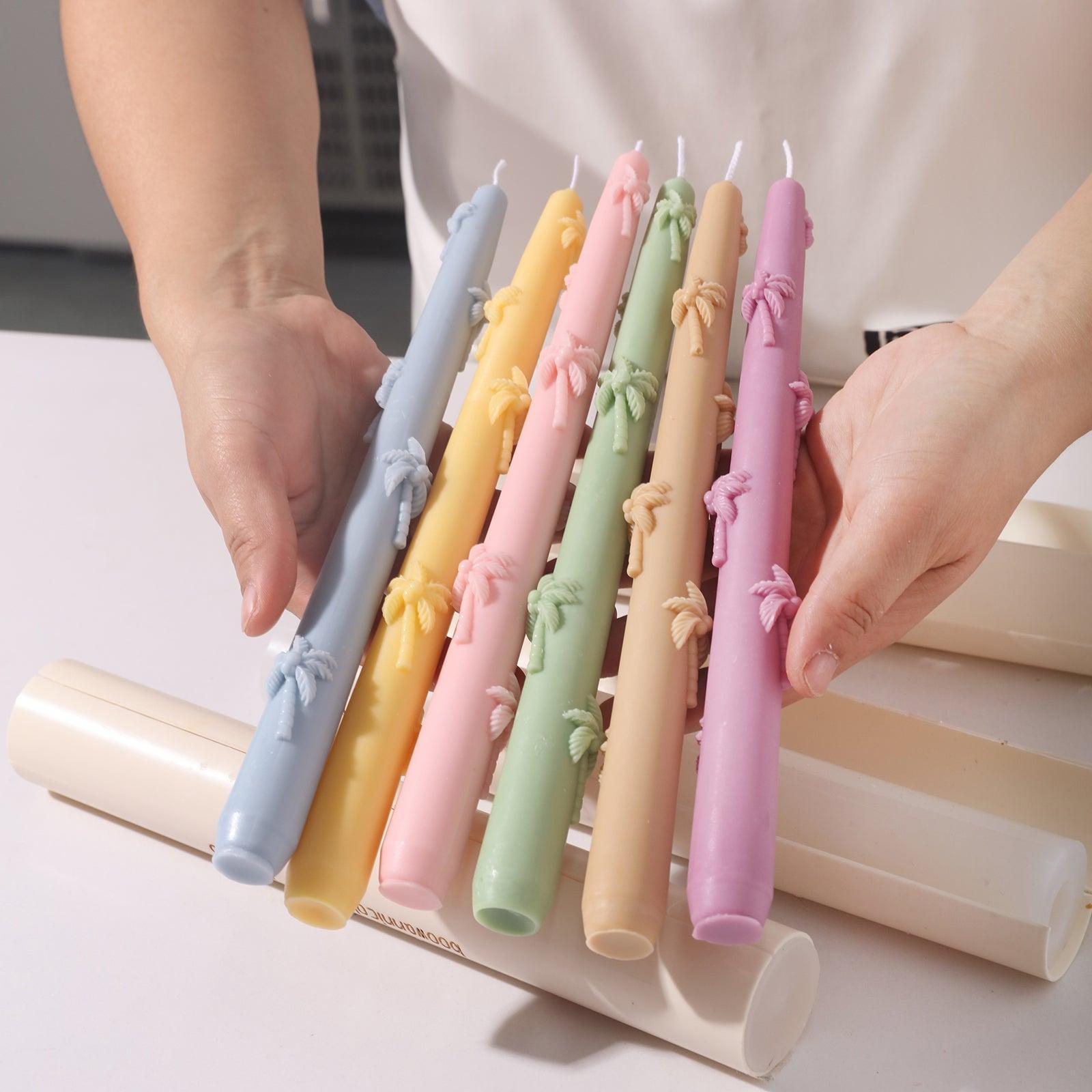 Unmoulded palm tree embossed taper candles in different colors.