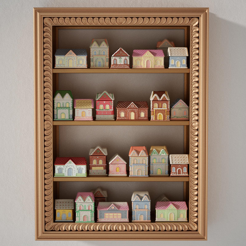 Wooden shelf with hand-painted gingerbread house candle jars in pastel mica finishes for Christmas decor - Boowan Nicole