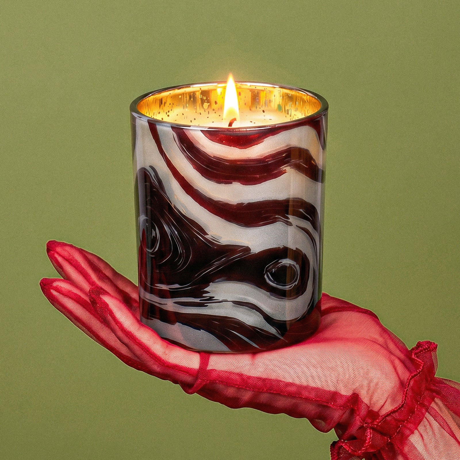 Hand Holding Lit Elegant Burgundy Marble Swirl Printed Gold Electroplated Gloss Glass Candle Jar With Red Mesh Evening Glove - Boowan Nicole
