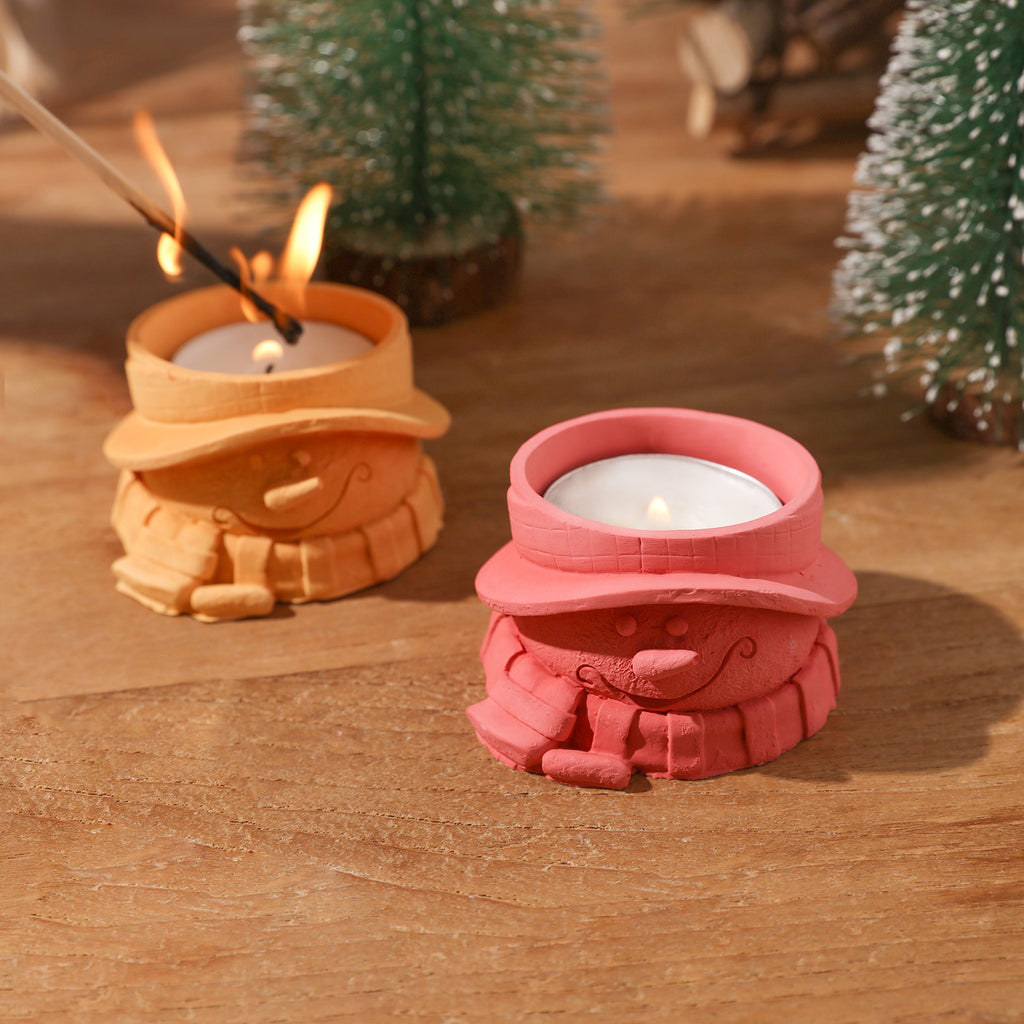 Lighting candles in yellow scarfed Christmas snowman tea light candle holder - Boowan Nicole
