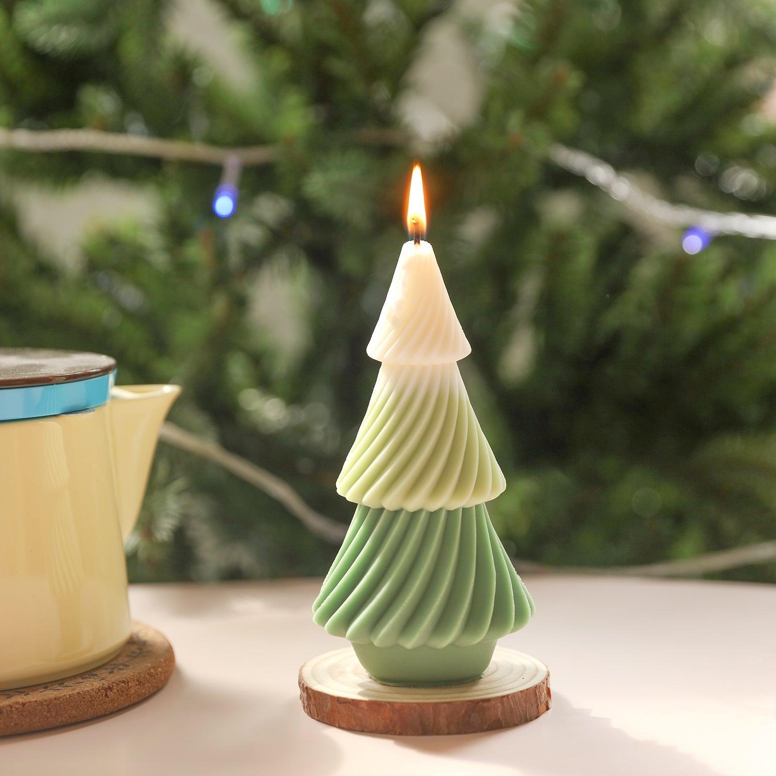Lighting the green and white evergreen Christmas tree candles placed in a log pallet - Boowan Nicole