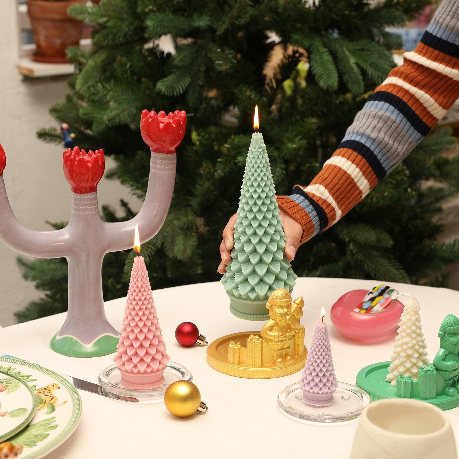 Place burning green tapered Christmas candle on table - Boowan Nicole