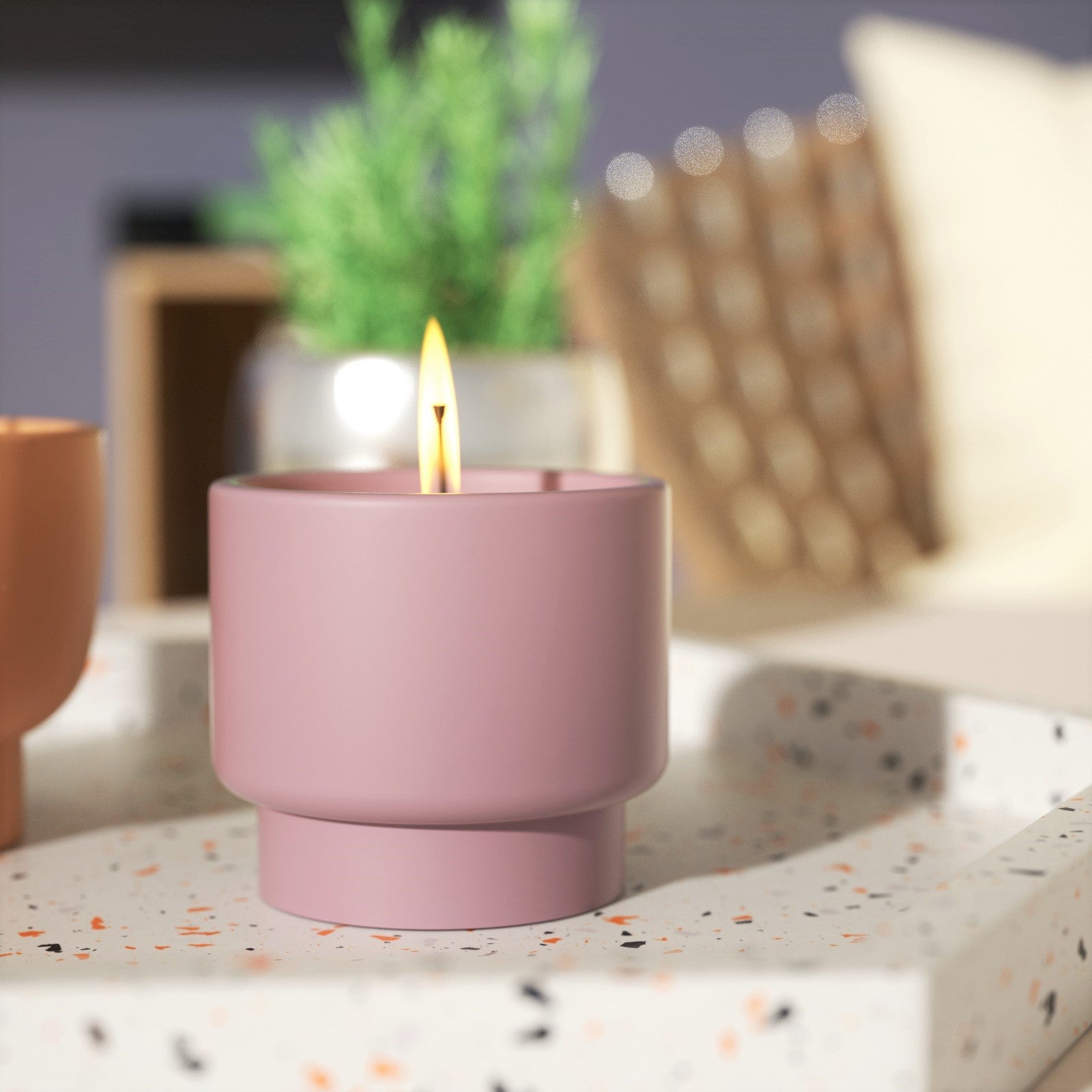 Lit candle in brown boowannicole bowl jar, gracefully placed on a tabletop.