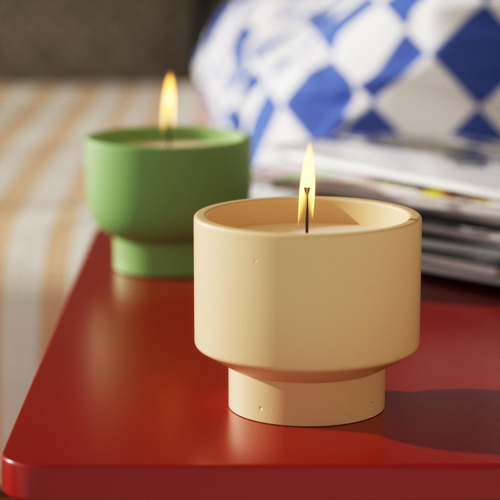 Bowl-shaped candle jar is burning on the table