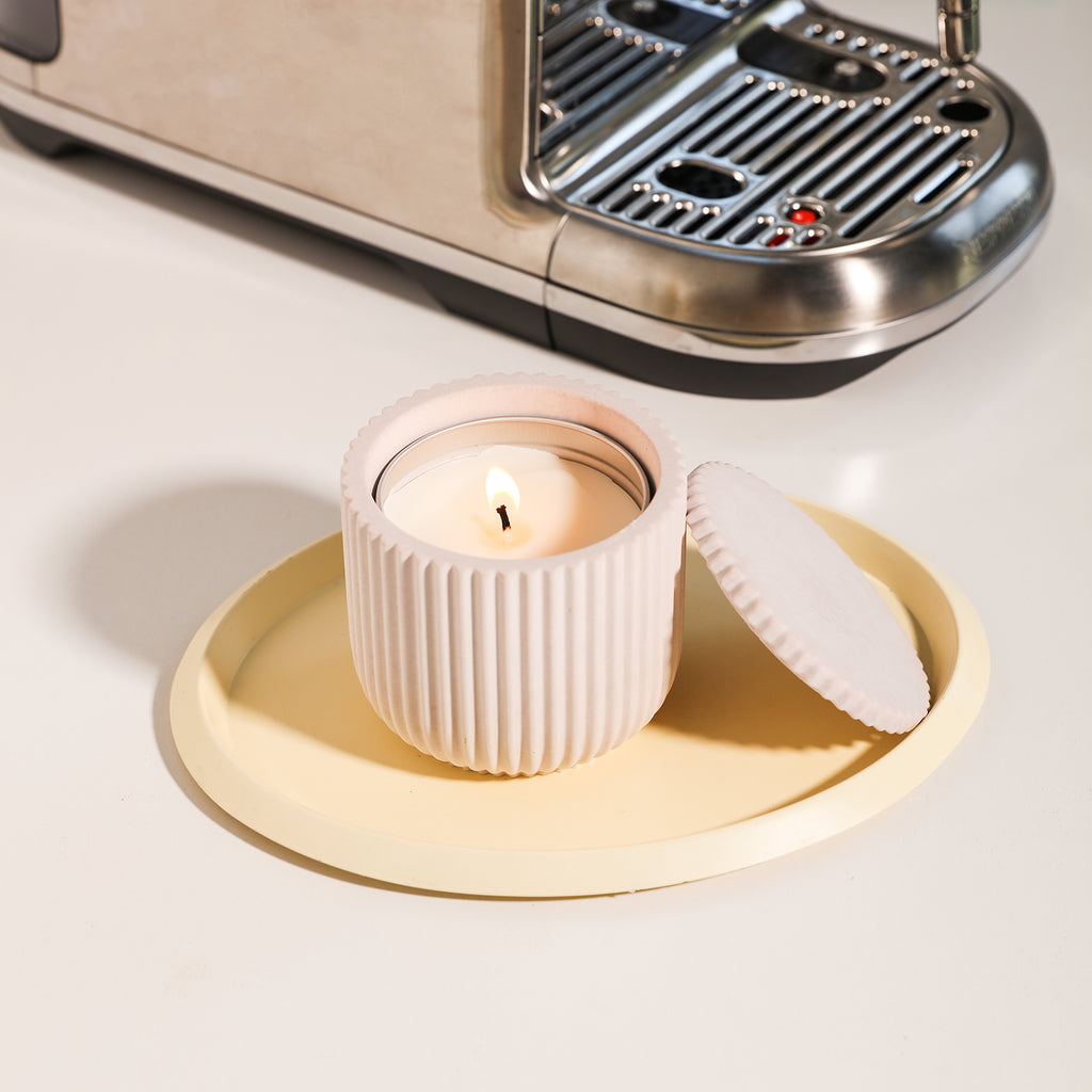 The refillable candle is being lit in the ridged flat-lid candle jar on the tray. It is the perfect size and carefully designed by BoowanNicole.