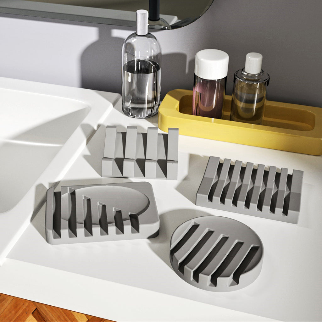 Add a touch of sophistication to your sink area – four grey soap dishes delicately placed on the washbasin, a perfect blend of form and function.