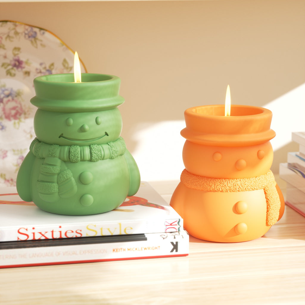 Candles burning slowly in the green and yellow Cheery Snowman's Winter Glow Candle Jar - Boowan Nicole