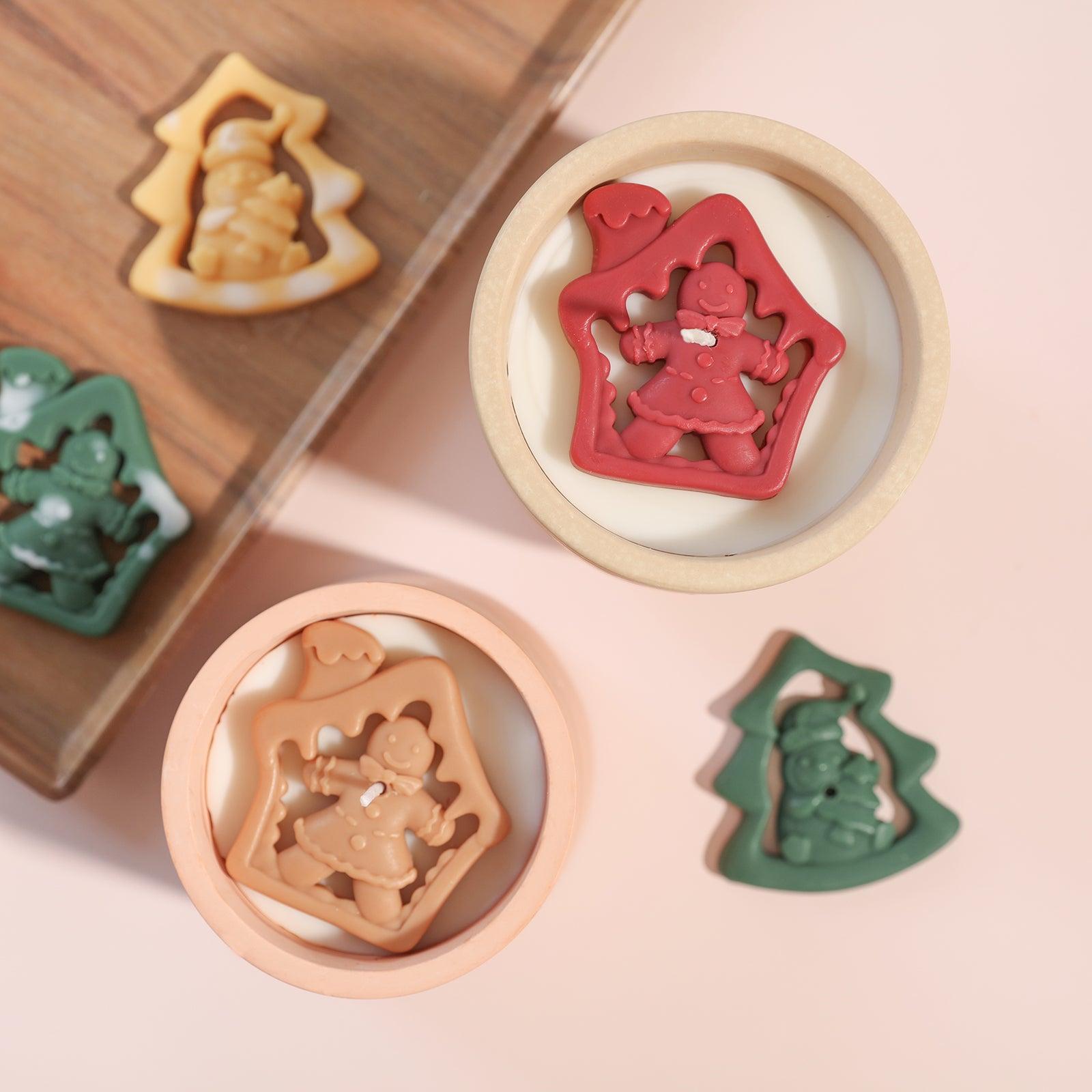 Red and brown gingerbread man shaped candle jar decorations placed in two candle jars on the table - Boowan Nicole