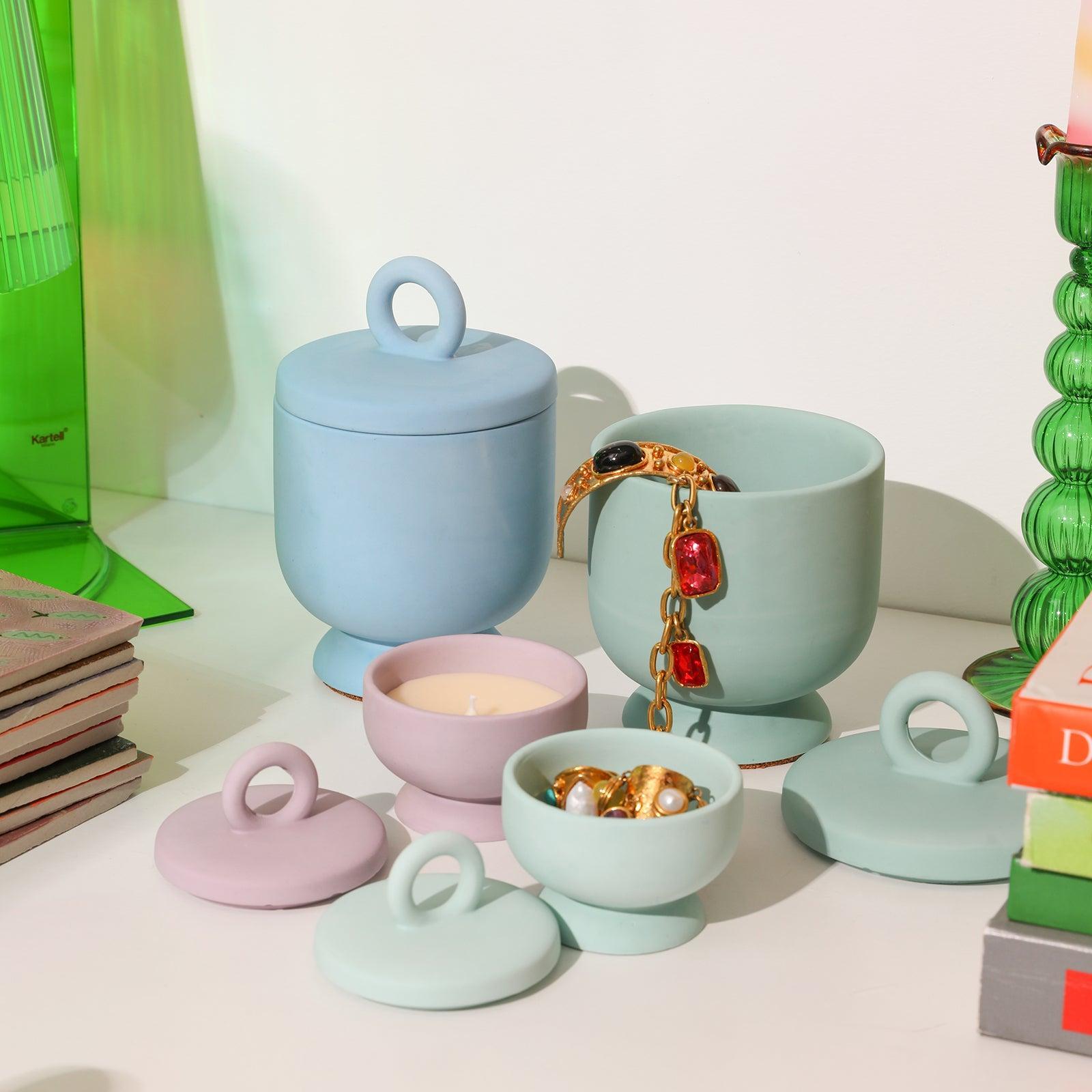 A bracelet is placed in the blue Chalice Candle Jar with Ring Handle Lid, which broadens the usage scenarios-Boowan Nicole