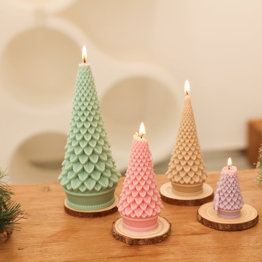 Four tapered Christmas candles of different sizes burning on a log pallet - Boowan Nicole