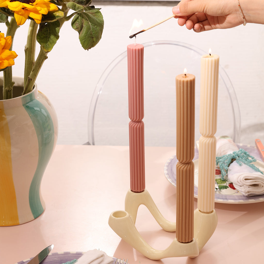 Light the three pink, brown and white Doric Pillar Taper Candle on the candlestick -Boowan Nicole