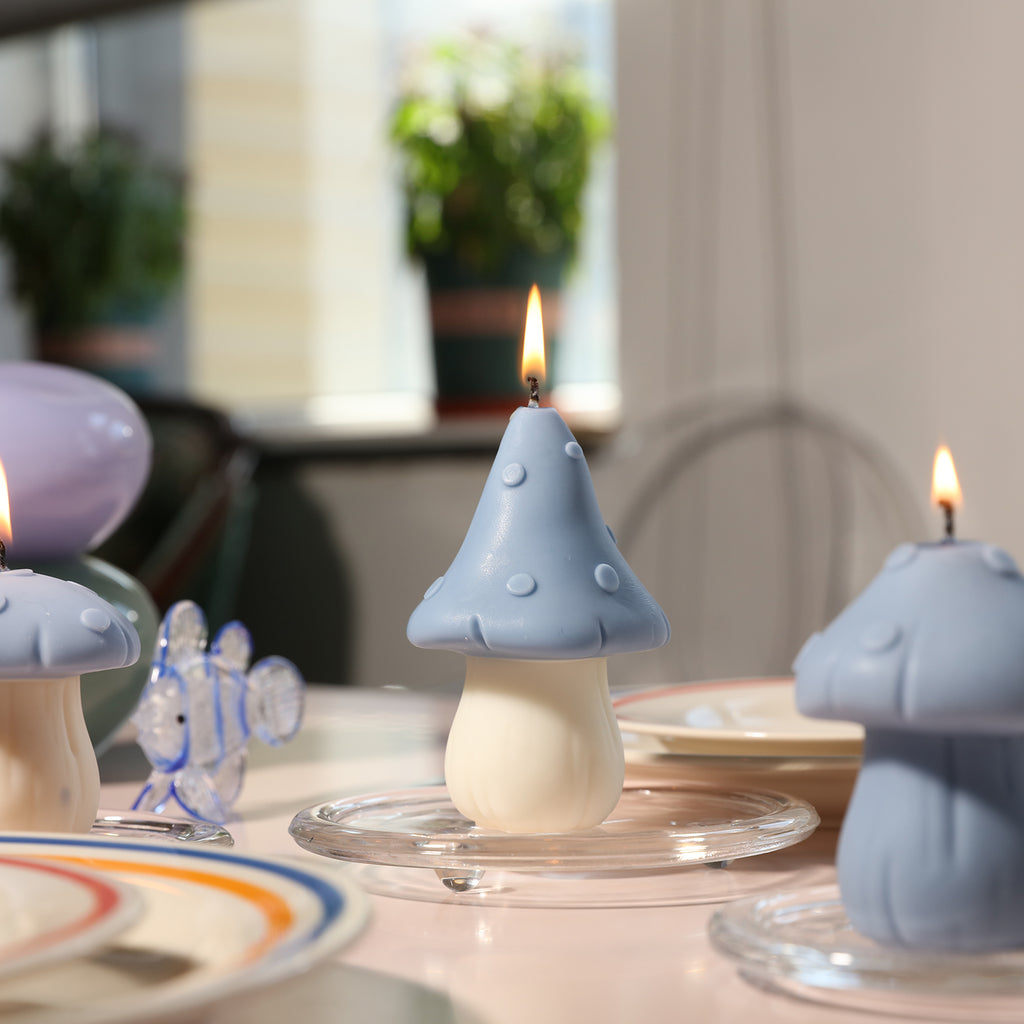 The blue canopy jungle mushroom candle is burning in the crystal tray on the dining table, designed by Boowan Nicole.