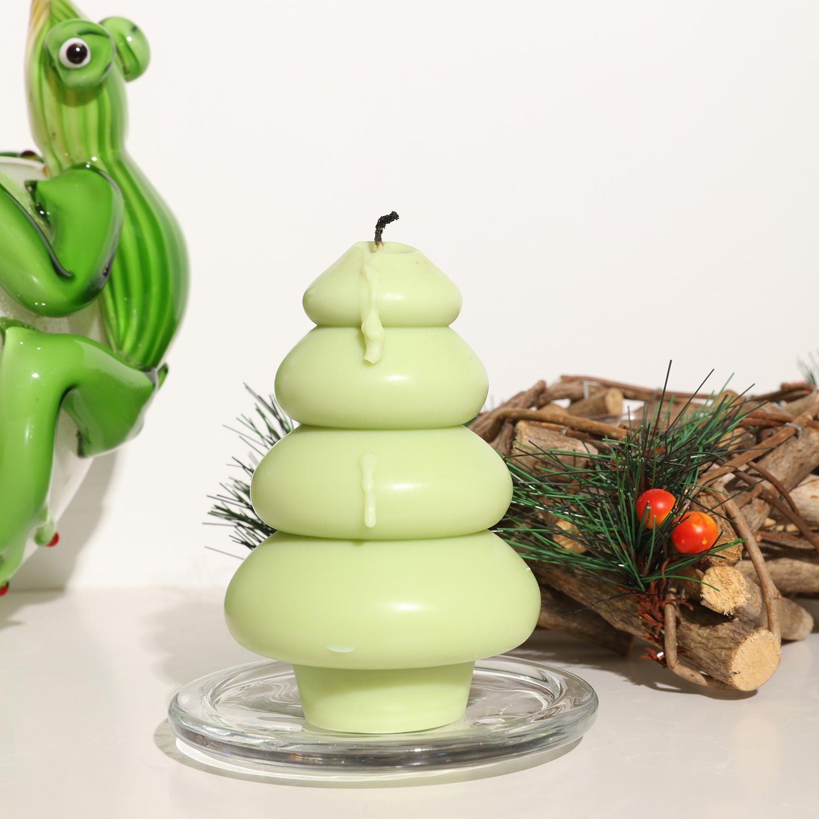 Extinguished green stacked circle Christmas tree candles in crystal tray on table - Boowan Nicole