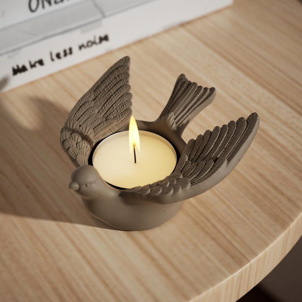 Lighting the candle inside a golden Joyful Bliss Bird Tealight Candle Holder.