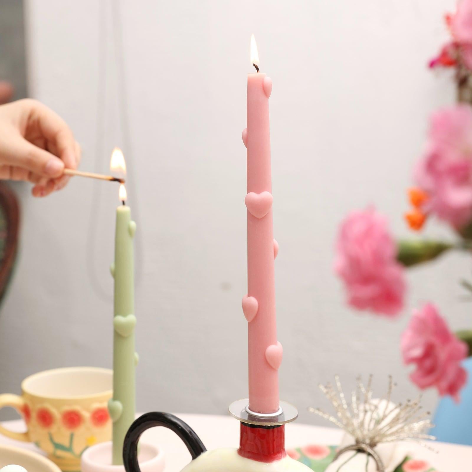 Ignite the vibrant glow of a green Love Heart Taper Candle, adding a touch of color to any setting.