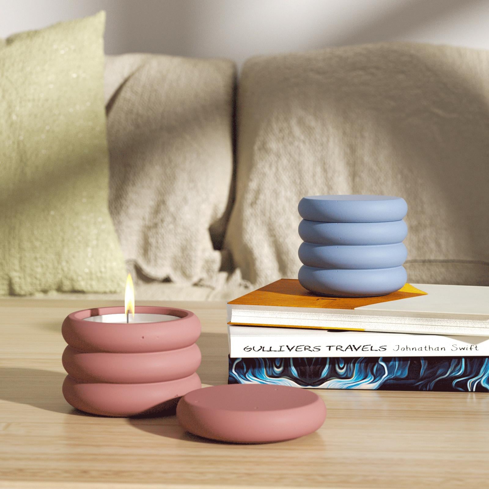 Two candle jars on the table, one of which is lit, add a warm scene to the home.