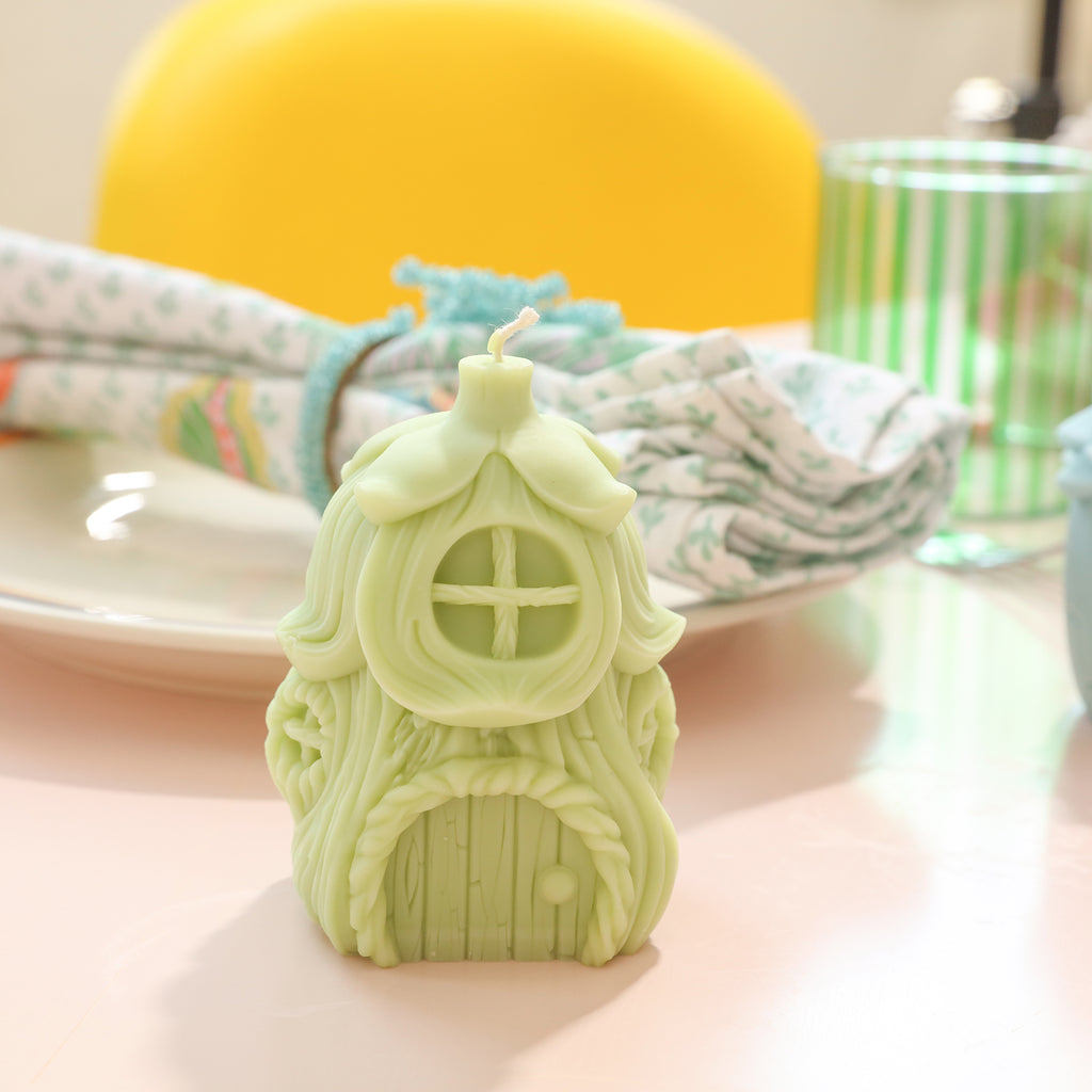 Green miniature fairy house candles placed on the dining table - Boowan Nicole