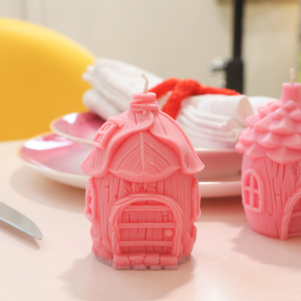 Pink fairy tale mushroom house candles placed on the table - Boowan Nicole