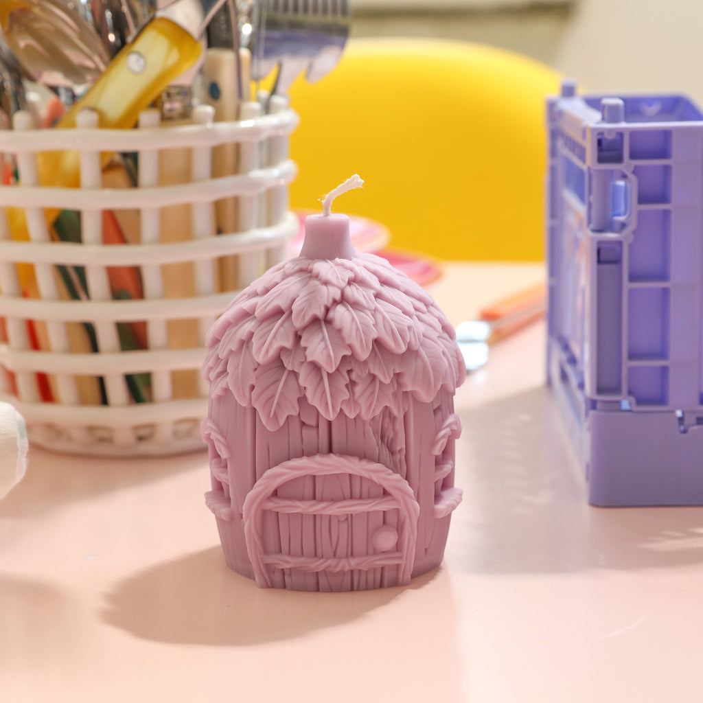 Purple miniature fairy house candles placed on table - Boowan Nicole