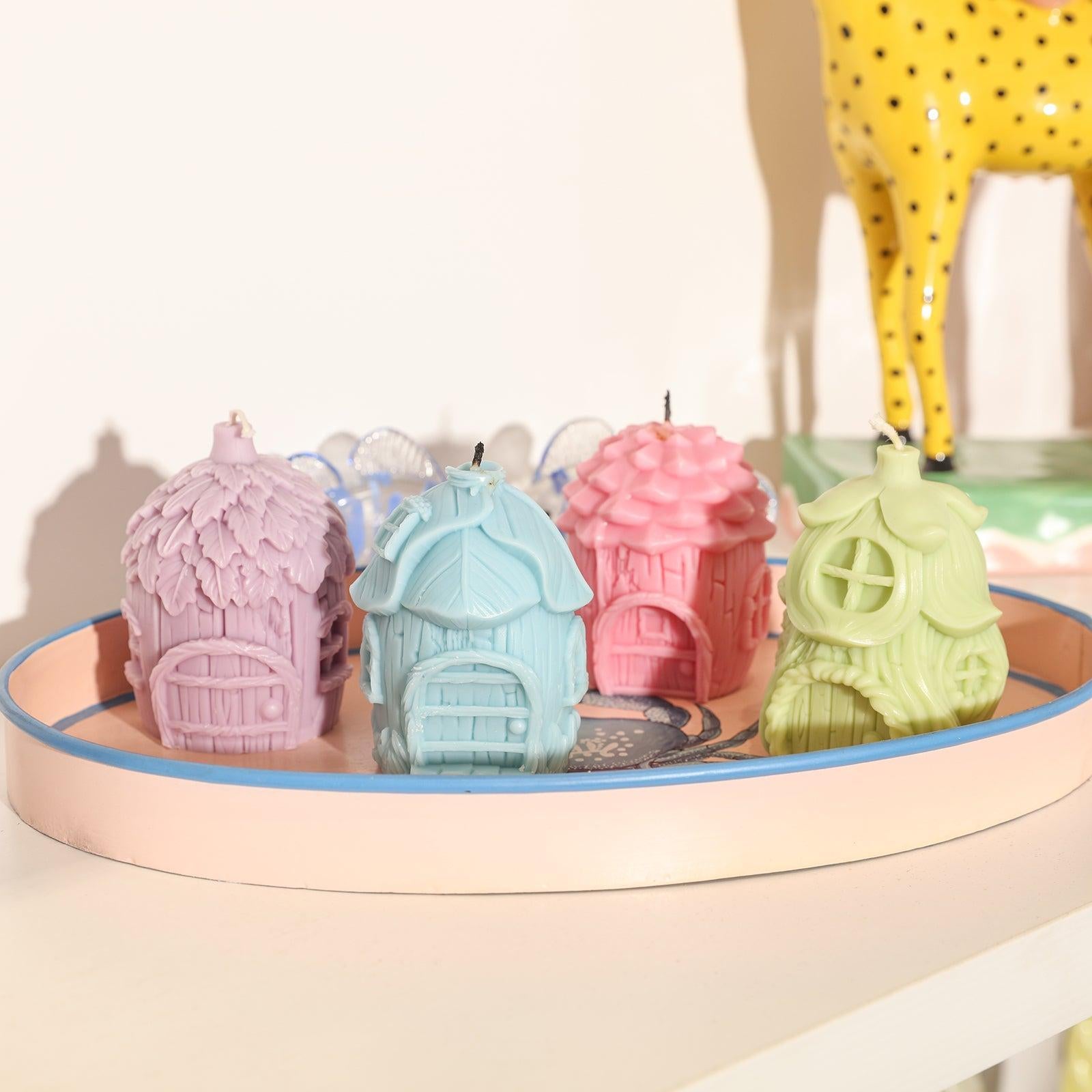 Four fairy house wax liquids of different shapes in pink, blue, purple and green are placed on the tray-Boowan Nicole