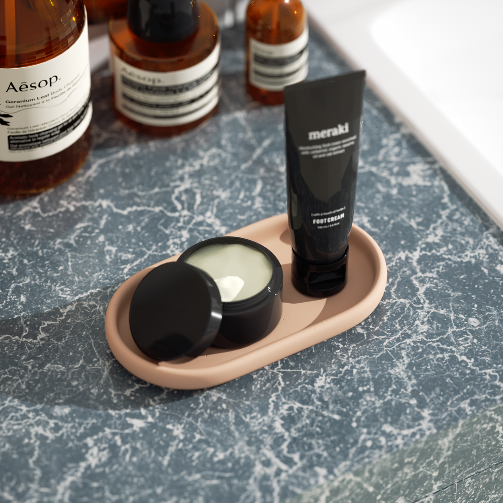 Minimalist Oval Tray Silicone Mold holding body lotion and facial cleanser next to the sink - Boowan Nicole