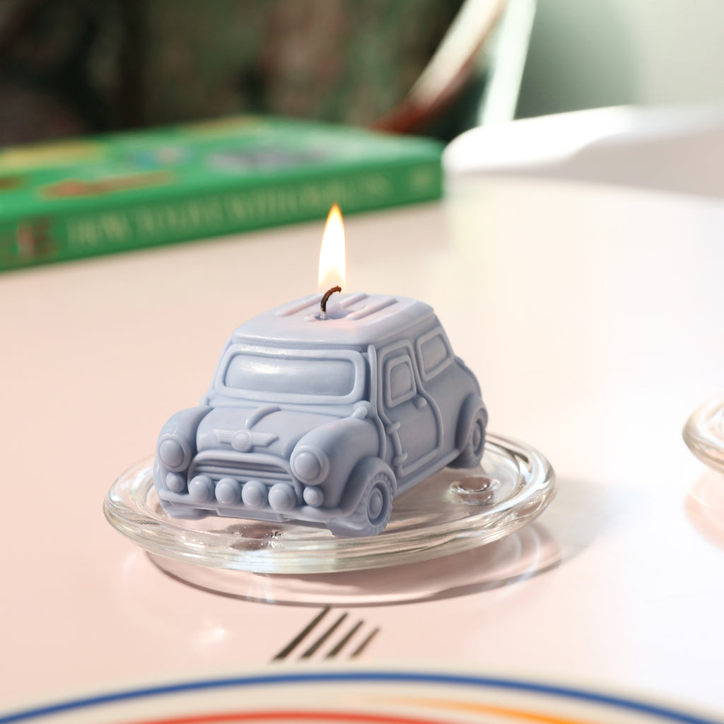 Blue retro car-shaped candle on a crystal tray, designed by Boowan Nicole.