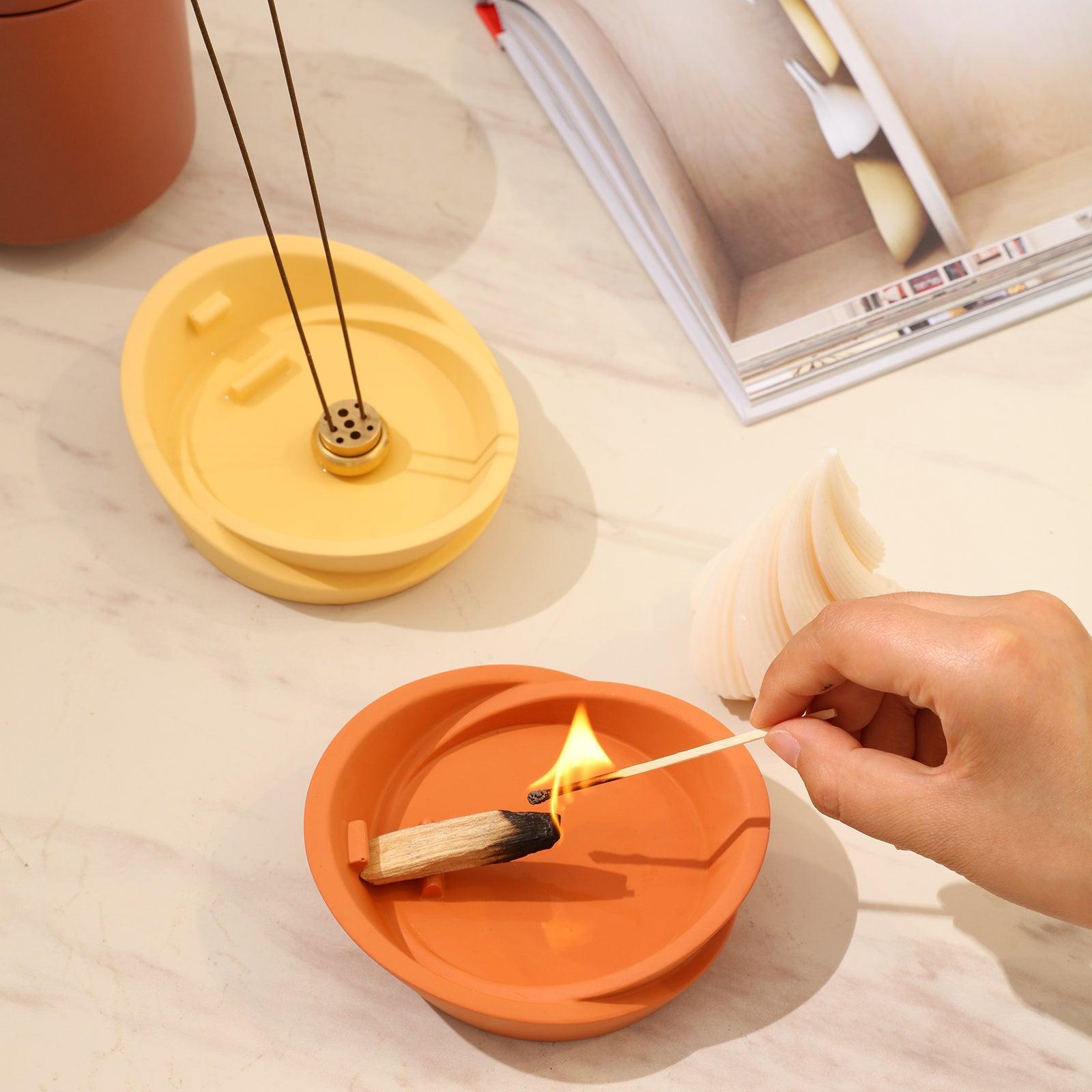 The yellow Sail-Shape Incense Holder is filled with incense sticks, and the reddish-brown Sail-Shape Incense Holder is filled with incense sticks - Boowan Nicole