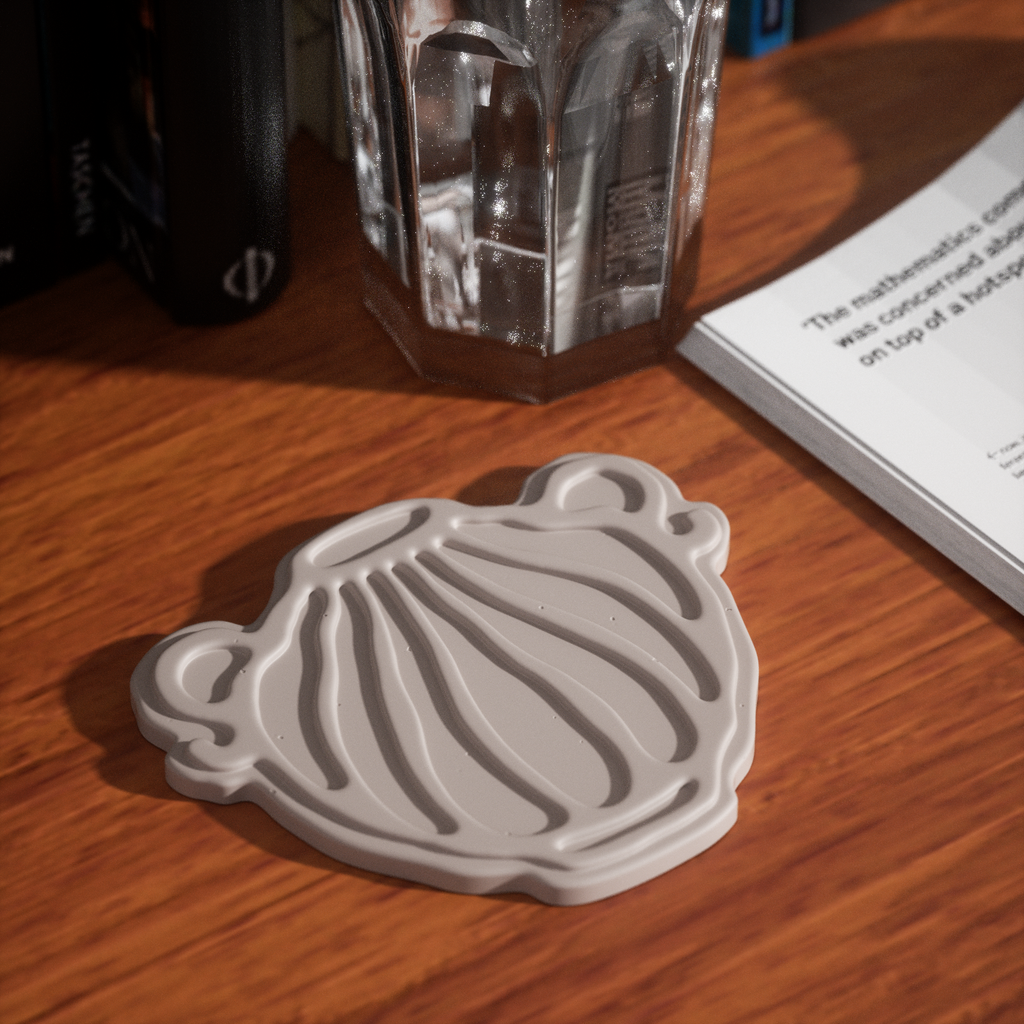 The gray wave-patterned water bottle-shaped coaster is placed next to the book to accompany you in your daily life. It is designed by Boowan Nicole.