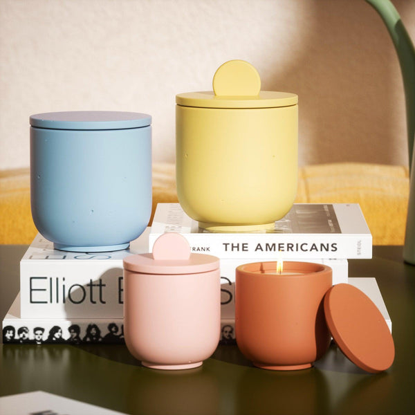 Display of candle jars with various colors and shapes of candle jar lids.