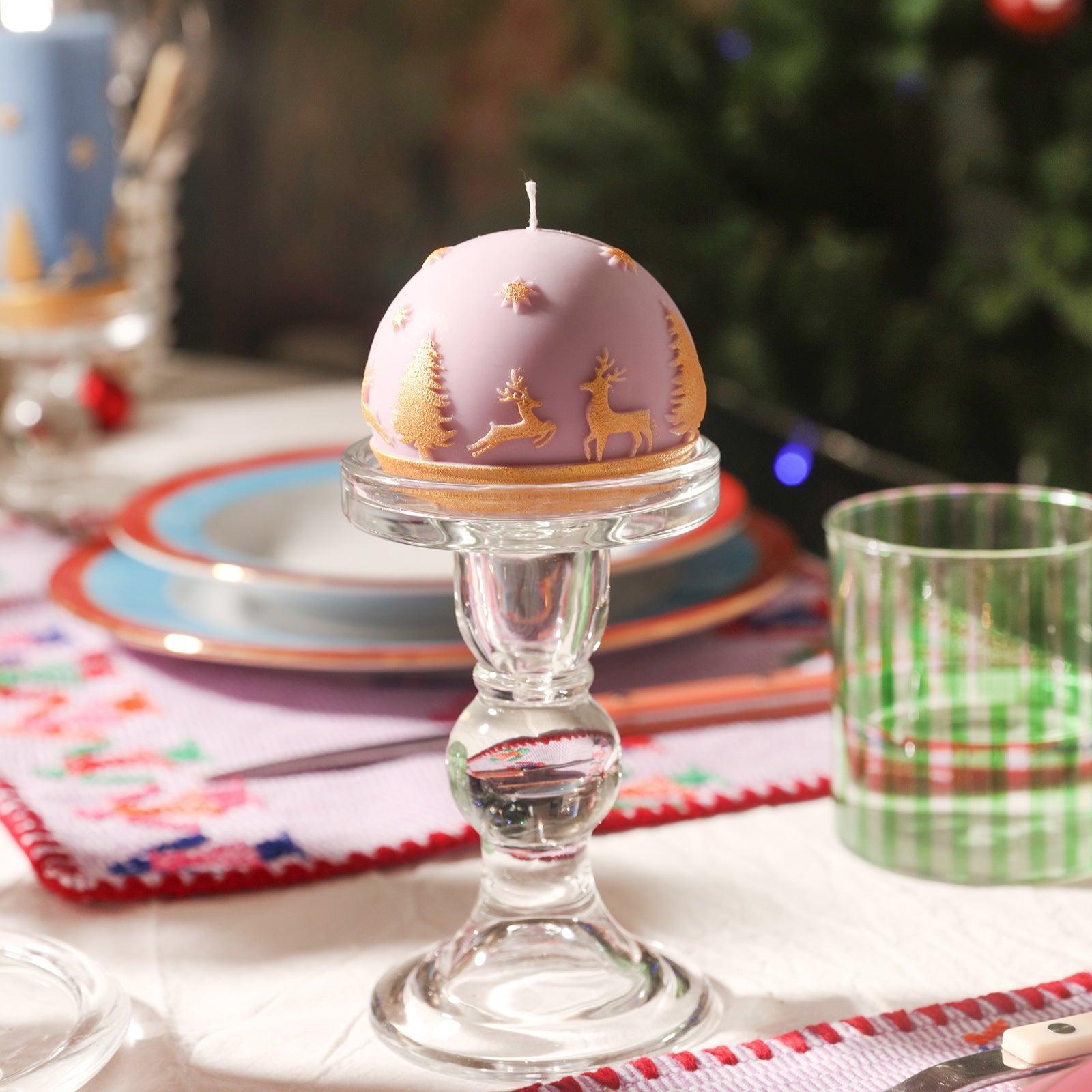 Purple spherical Christmas candles placed on crystal candle holders designed by Boowan Nicole