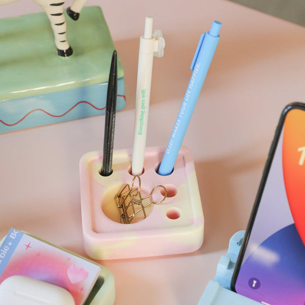 In the pink Square Multi-Functional Stationery Support, there are three pens and a swallowtail clip-Boowan Nicole