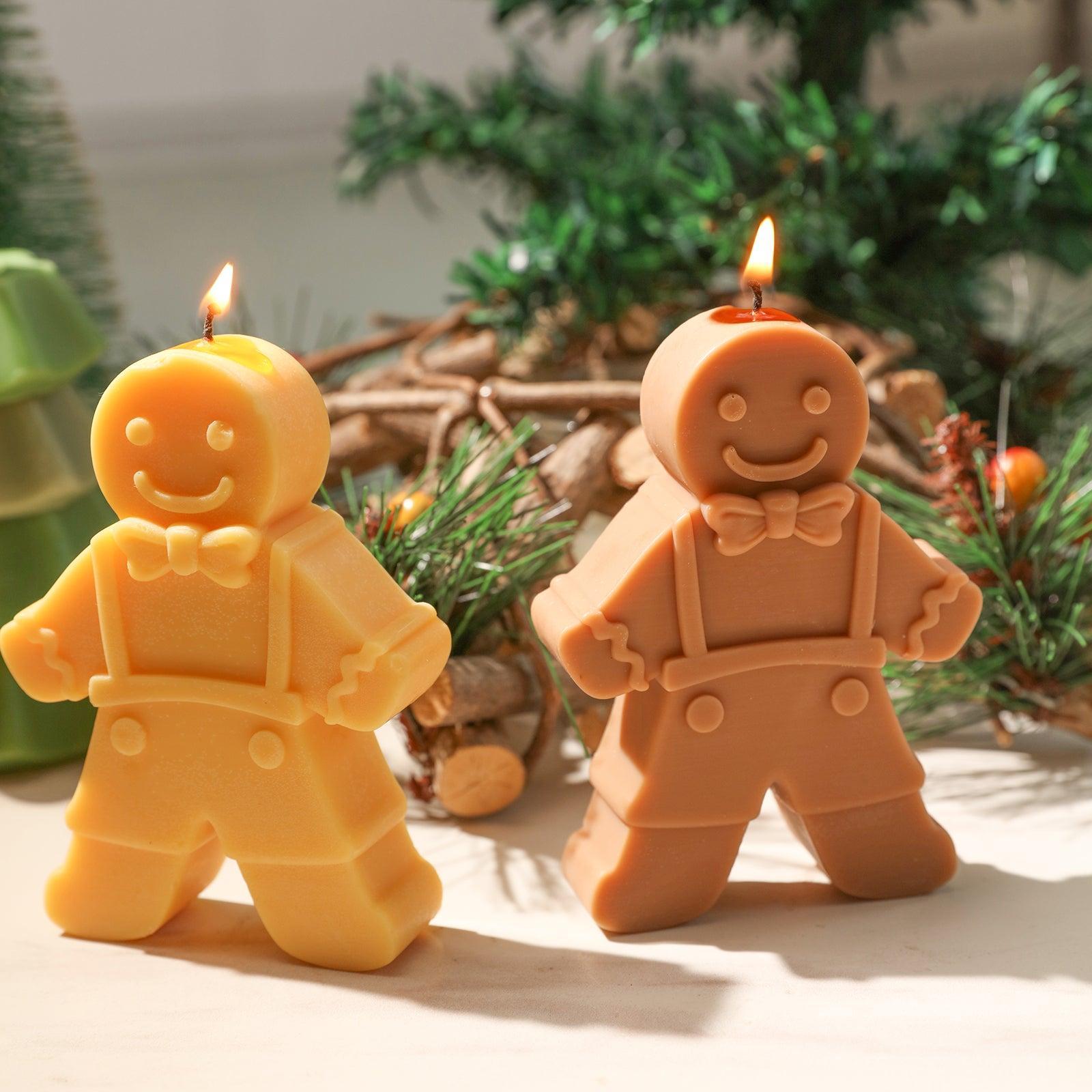 Lighted yellow and brown Gingerbread Kid candle on Christmas decorated tabletop - Boowan Nicole