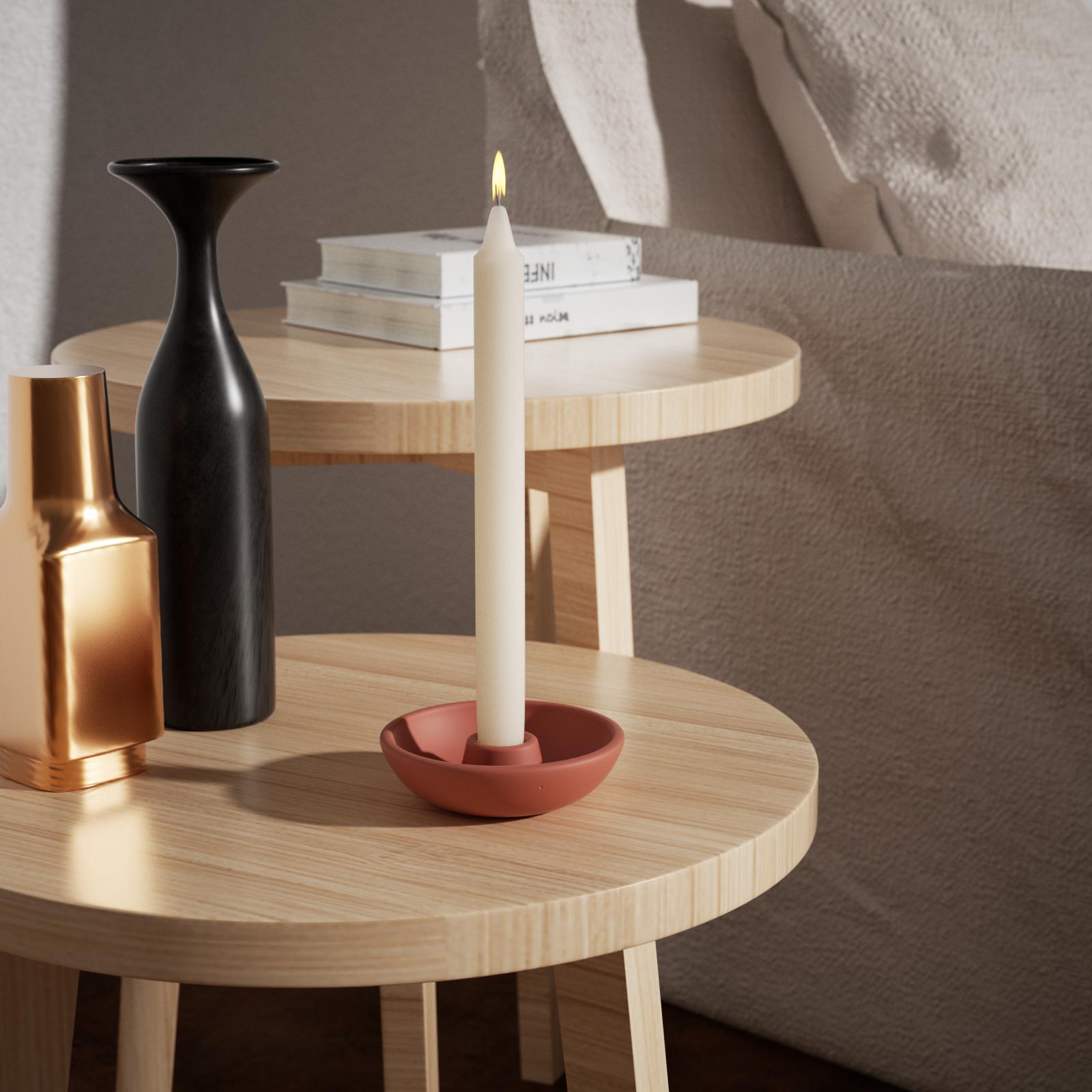  Candle lit on the holder serves as an eye-catching home decor.