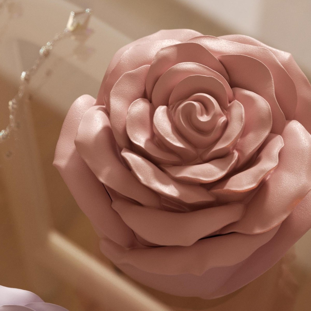 Close-up of a handcrafted rose-shaped candle in soft pink color, highlighting its layered petal details and smooth glossy finish - Boowan Nicole