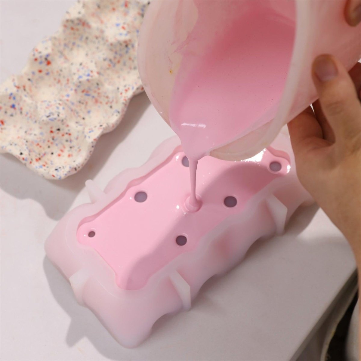 Pour the mixed Boowannite material and pink pigment into the silicone mold - Boowan Nicole