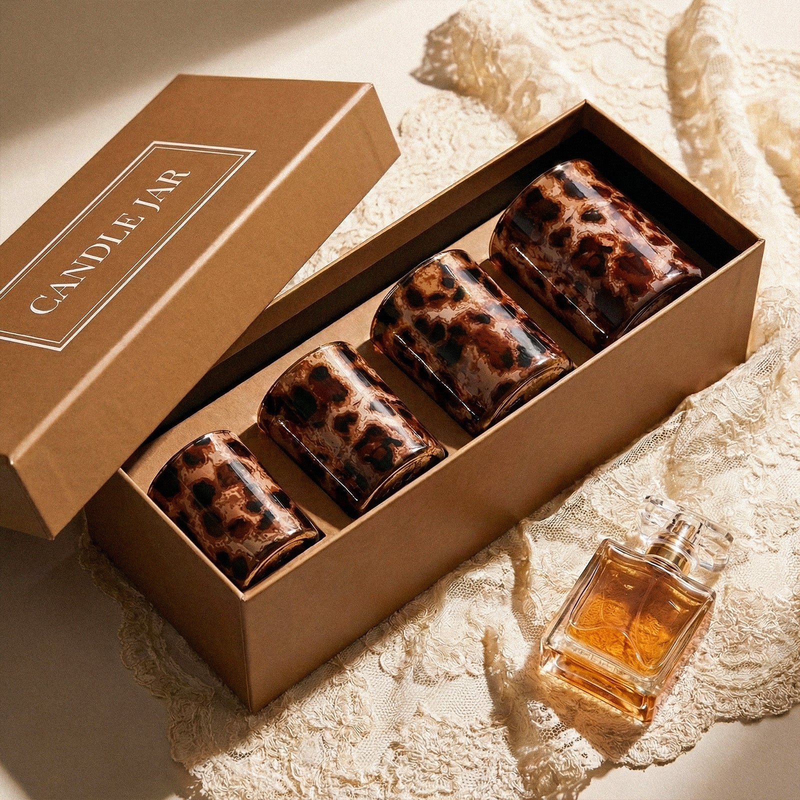 Four-Piece Tortoise Shell Candle Set Packed in Premium Kraft Gift Box Beside Clear Perfume Bottle - Boowan Nicole