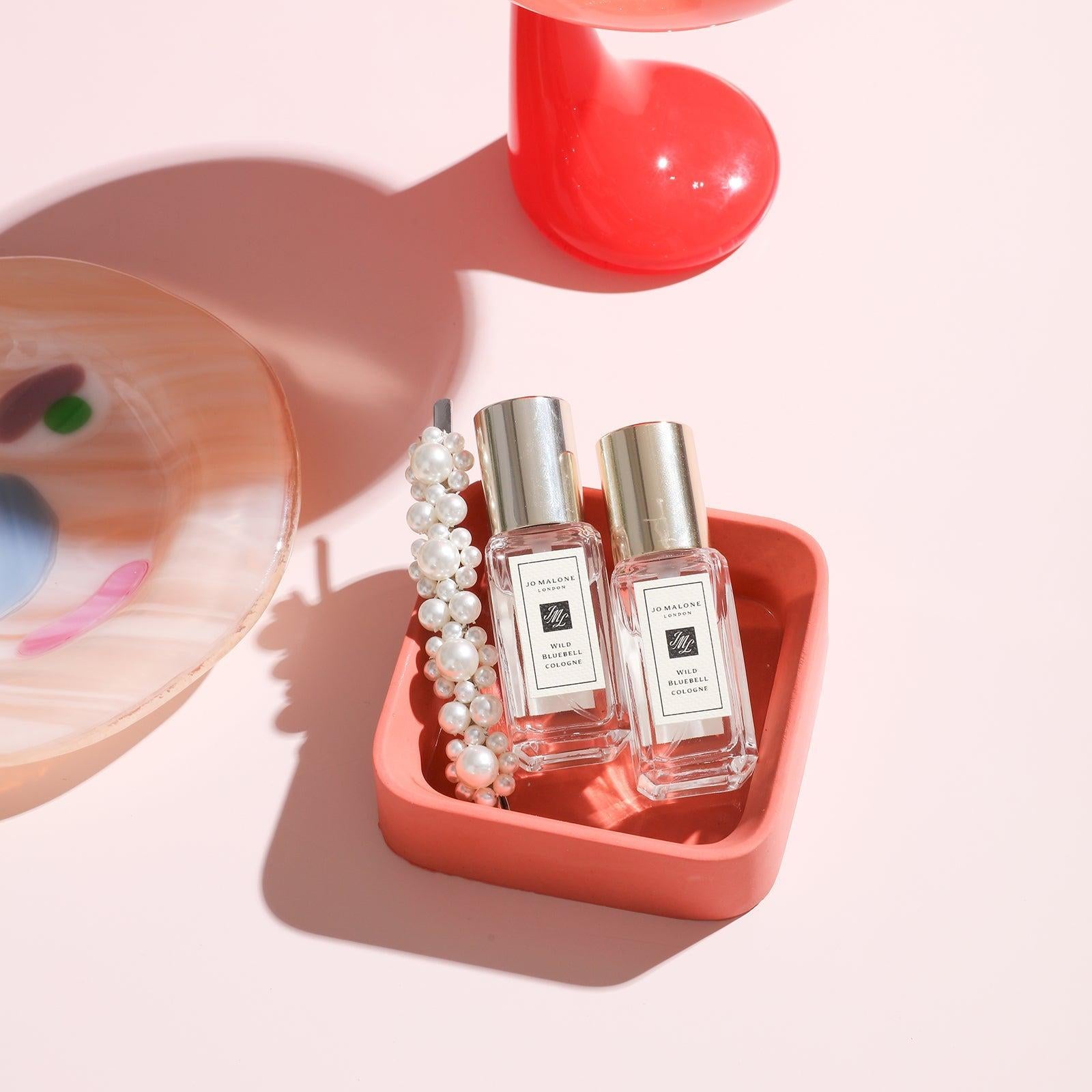 Red Square Small Desk Caddy holding perfume on the table - Boowan Nicole