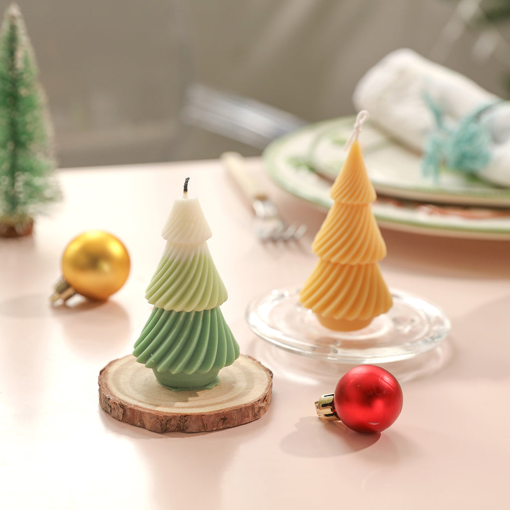Yellow evergreen Christmas tree placed on a log tray and green and white evergreen Christmas tree candles placed on a crystal tray - Boowan Nicole