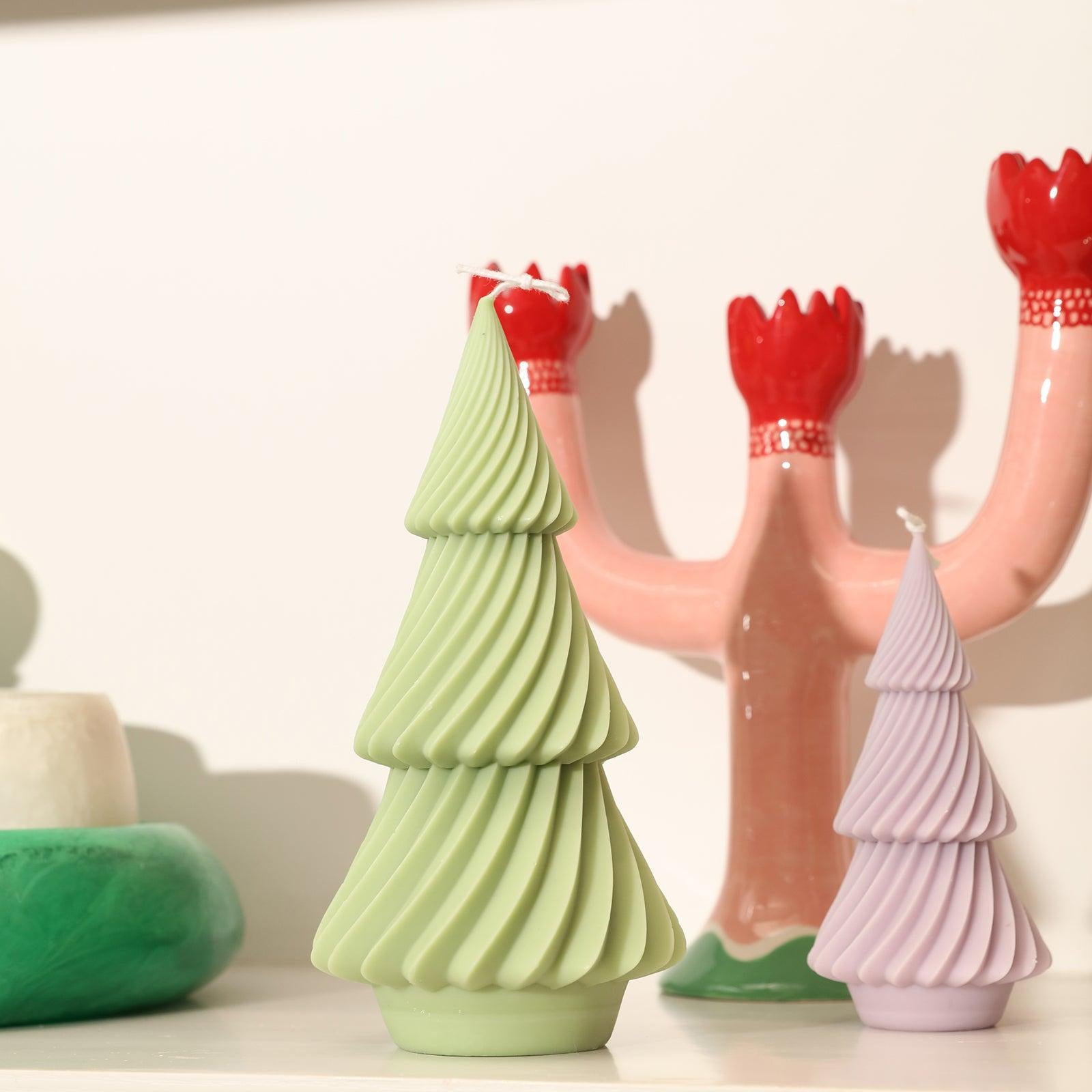 Large green and medium purple evergreen Christmas tree candles placed on desk - Boowan Nicole