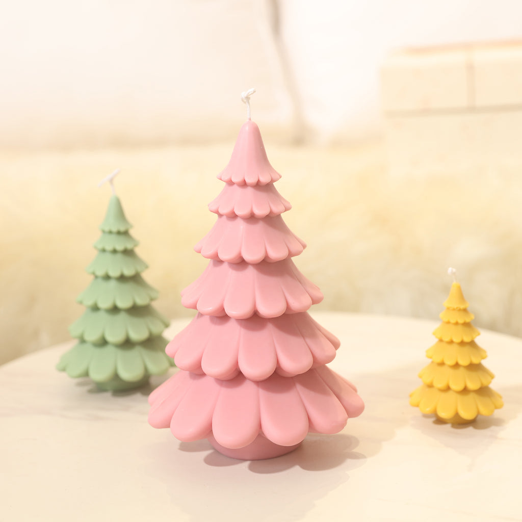 Layered Christmas tree candles in three different sizes, pink, green and yellow, designed by Boowan Nicole.