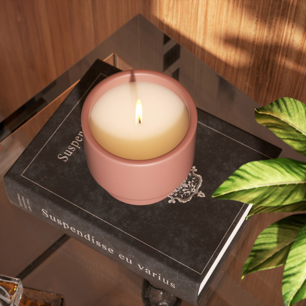 Overhead view of burning boowannicole candle jar, displayed on top of a book, creating a unique decorative effect. 
