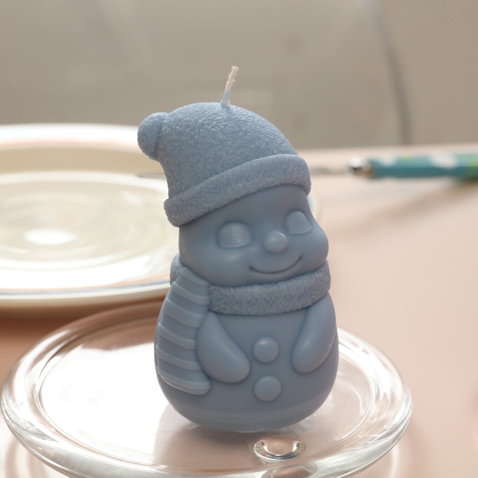 Blue Lovely and Shy Snowy Friend Candle placed in a crystal tray on the table -Boowan Nicole